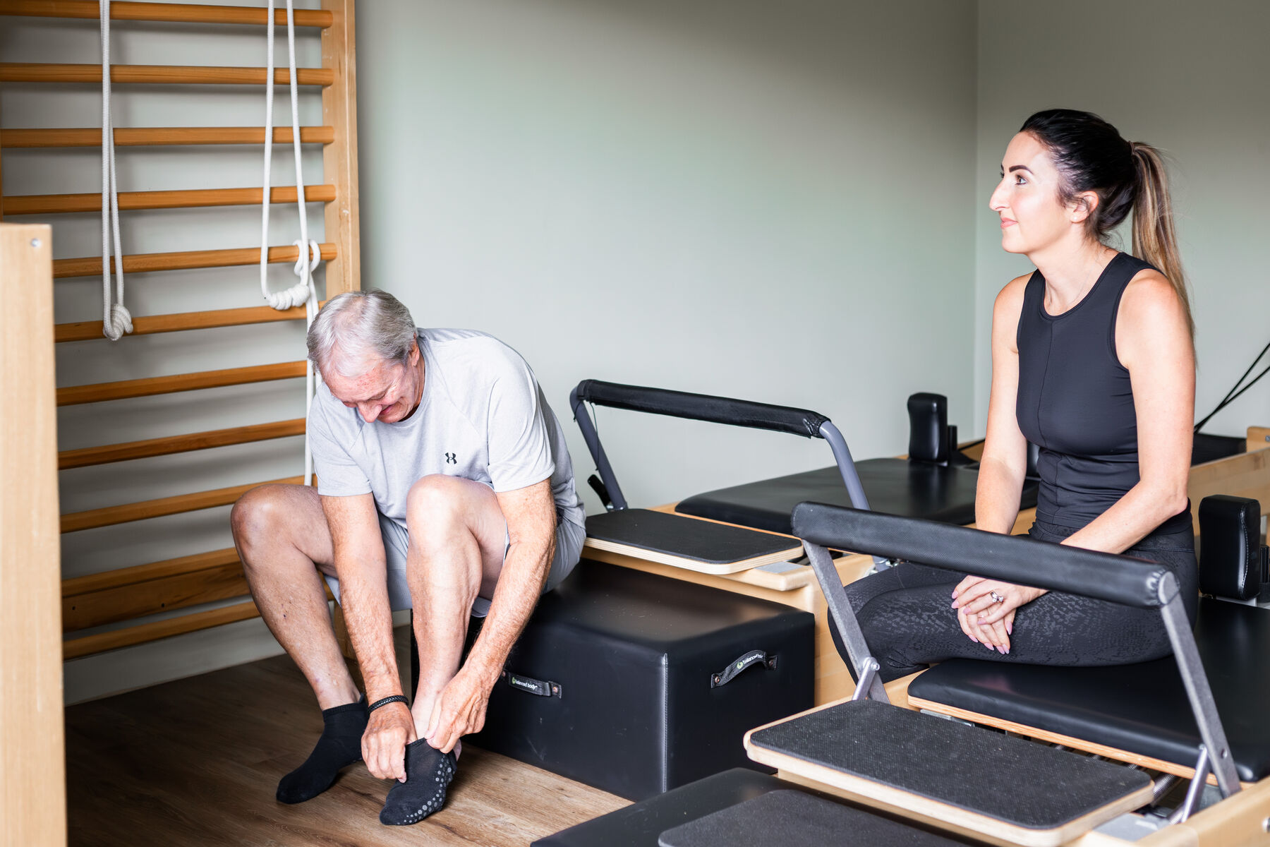 Two clients chatting between exercises in the studio