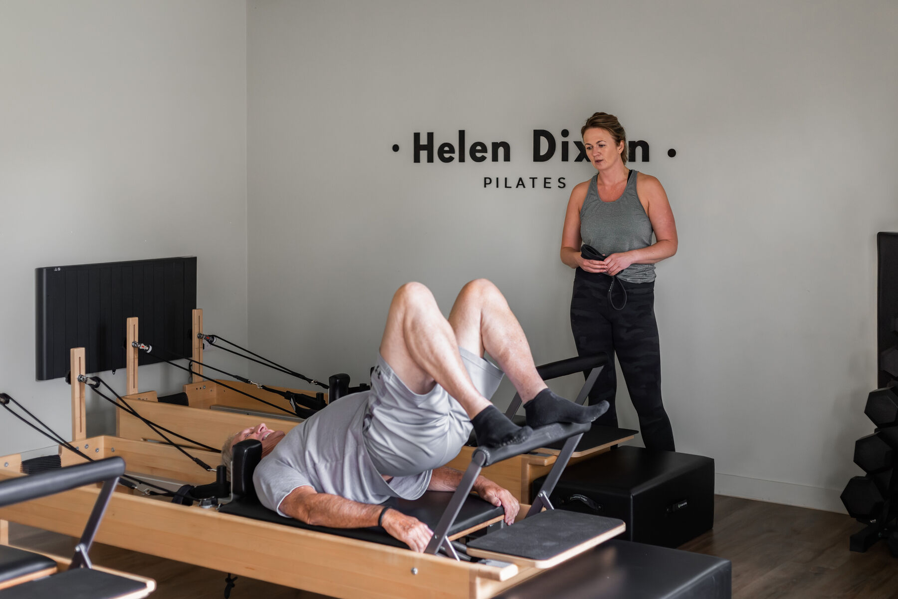 Helen coaching a client one to one on the Reformer